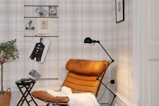 26 an amber leather chair, a floor lamp and a blanket for comfortable reading and enjoying coziness