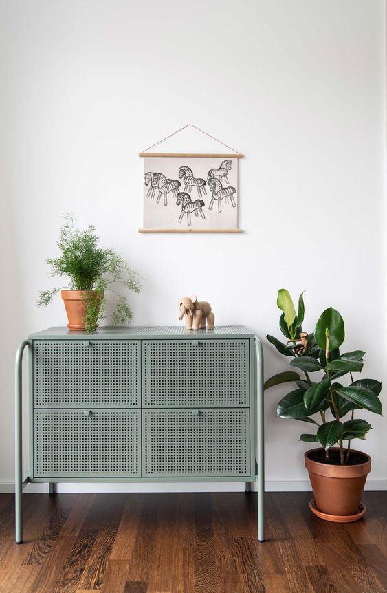 a Nikkeby sideboard by IKEA done in olive and with cane webbing is a stylish way to add a bit of color and chic to the space