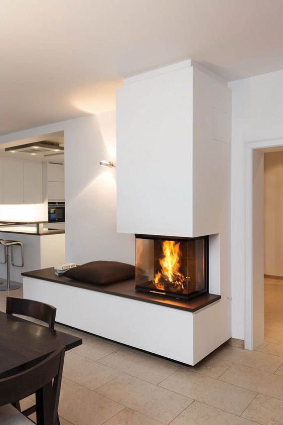 a contemporary fireplace with a bench to enjoy it and a glass cover to make the fire all visible