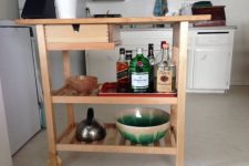 a mini bar made of an IKEA Forhoja cart is a cool rustic idea for your home and a nice use of your space