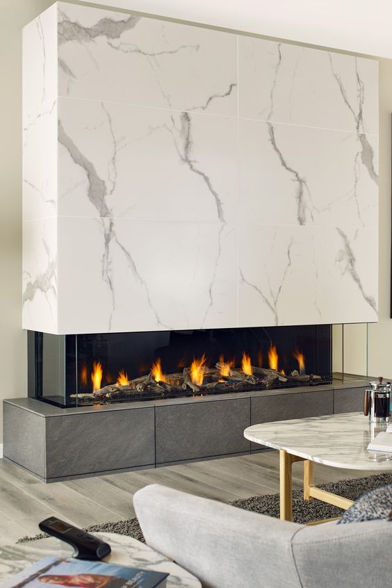 a minimalist fireplace with a dark tile base and a white marble hood plus a glass cover is a very refined idea
