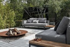 a modern deck with chic grey sofas, wooden tables, a metal fire pit and lots of greenery around is a perfect space to invite guests