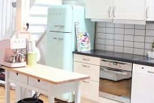 a space-saving kitchen island of an IKEA Forhoja cart painted white and with a wooden countertop