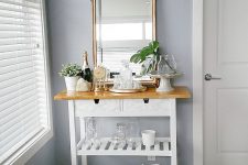 a stylish IKEA Forhoja cart hack with white paint, a light-stained countertop and drawers finished with marble contact paper