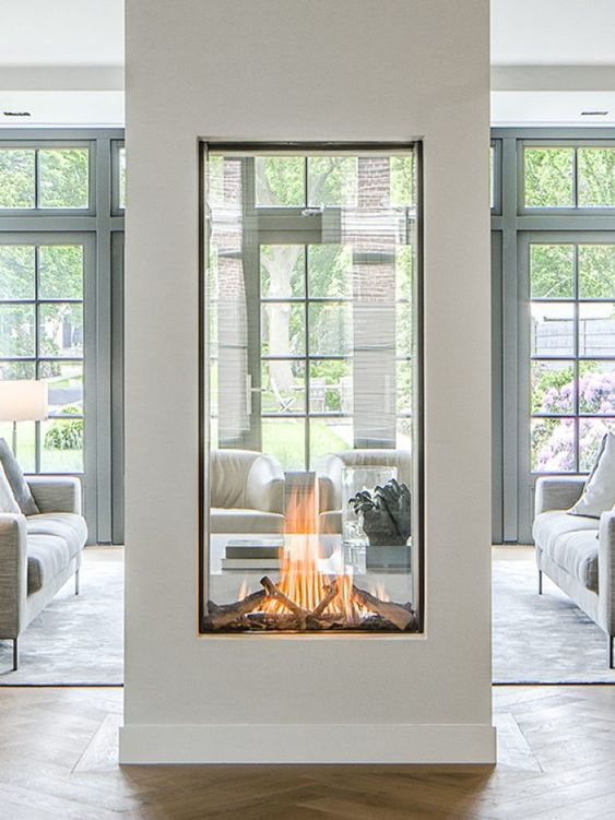 a two sided fireplace with glass will provide two spaces with a beautiful fire look and with coziness and chic