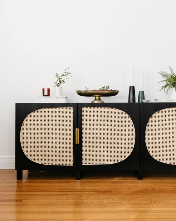 an IKEA Besta TV unit done very contrasting, in black and with can webbing plus gold handles is a bold idea