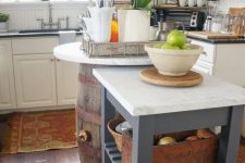 an IKEA Forhoja cart cut in half and painted graphite grey, with a white marble countertop is a nice and stylish kitchen island