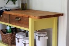an IKEA Forhoja cart painted yellow, with a stained wooden countertop and wine crate drawer fronts is a bold idea to rock