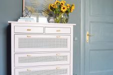 an IKEA Hemnes dresser hack done with blush paint, cane webbing and chic handles is cool for a modern space