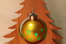 02 a tabletop plywood Christmas tree on a wooden stand with a single large ornament is a cool idea for some small space