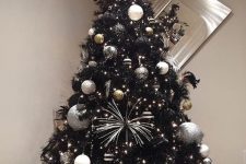 04 a black Christmas tree with lights, white, silver and black ornaments, silver touches and ribbons is pure glam and chic