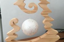04 a carved out wooden tabletop Christmas tree with a single ornament hanging inside is a very cool idea for holidays