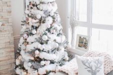 04 a flocked Christmas tree decorated with faux fur, silver leaves and pearl and white ornaments is super chic