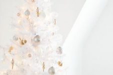 06 a pure white Christmas tree with lights, silver, gold and pearly ornaments and a pretty shiny snowflake tree topper