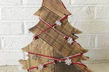 08 a wooden tabletop Christmas tree decorated with yarn, beads and mini snowflakes is a lovely decoration with a rustic feel