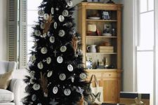 09 a black feather Christmas tree with vintage letter ornaments and pampas grass plus gifts under it and on a sleigh