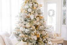 09 a glam gold and white Christmas tree with ribbons, metallic ornaments, twigs and leaves plus piles of gifts