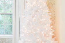 09 a white pre-lit Christmas tree is pure elegance and chic and is ideal to create a winter wonderland feel in the space