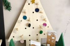 10 a plywood tabletop Christmas tree with perforations and colorful mini ornaments is a pretty idea for holidays