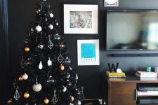 11 a chic black Christmas tree with white, copper, gold and silver ornaments and himmeli ones looks ultra-modern