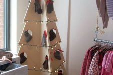 12 a 3D plywood Christmas tree with lights and stockings and mittens instead of usual ornaments