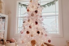 12 a white Christmas tree decorated with fluffy pompoms of earthy colors and put into a basket to make it look a bit rustic