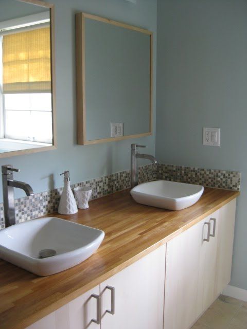 IKEA kitchen cabinets used to create a comfortable double vanity with stylish sinks, great and very easy to rock