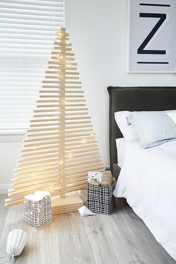 a minimalist plywood Christmas tree decorated only with lights is a great idea for a minimalist fan