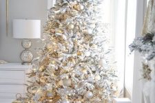 15 a white Christmas tree decorated with gold and silver ornaments and lights is a very beautiful holiday idea