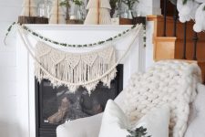 16 a macrame hanging and a beaded garland on the fireplace, 3D paper trees and branches on the mantel for a natural and boho touch