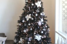 17 an elegant Christmas tree with silver, black, sheer ornaments, fabric flowers and snowflakes, lights and a lit up topper