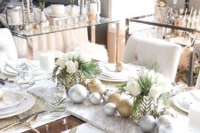18 a glam Christmas table setting with white linens, gold placemats and cutlery, white porcelain and white blooms
