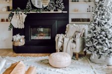 22 all-neutral Christmas decor done with a flocked Christmas tree decorated with white and silver ornaments, white pillows, blankets, stockings and a fir garland