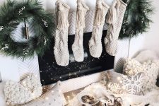 23 pretty white and neutral Christmas decor with stockings, white blooms, fir wreaths, neutral fluffy pillows, a faux fur rug and pompoms
