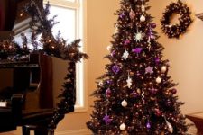 26 a wreath and tree in black is chic and purple adds just a pop of color to this living room and make it wow