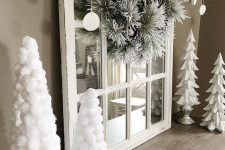 26 white Christmas decor with white paper and pompom Christmas trees, a flocked Christmas wreath with pinecones and clay ornaments with letters