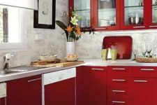 a bright modern red kitchen with wallpaper walls, white stone coutertops and simple handles plus artworks is amazing