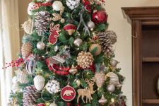 a bright rustic Christmas tree with plaid ribbons, bows and ornaments, large pinecones, bells and pretty plywood deer ornaments