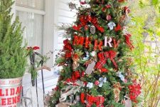 a bright rustic Christmas tree with plaid ribons and bows, lights, deer, pinecones, greenery and berries and some branches is lovely