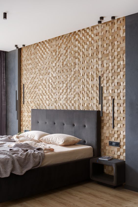 a chic contemporary bedroom with a wooden square accent wall, dark walls and furniture, catchy pendant lamps
