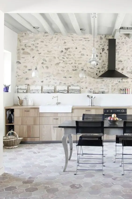 a contemporary kitchen made catchy with a whitewashed stone accent wall and neutral hex tiles on the floor