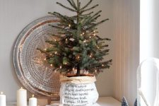 a cool tabletop Christmas tree with lights wrapped in printed paper is a cool idea for a Scandinavian space