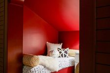 a double guest bedroom with red walls, red beds and printed bedding looks cool and very cozy