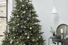 a gorgeous Christmas tree with sheer, white and gold ornaments, lights, star bead ornaments looks very laconic and very stylish
