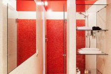 a minimalist red and white bathroom with tiny tiles covering it everywhere, white appliances, glass shelves and a white tile space divider