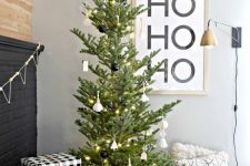 a modern Christmas tree decorated with white and black ornaments and with himmeli ones plus lights is a very cool and bold idea