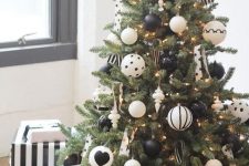 a monochromatic modern Christmas tree with black and white printed ornaments and polka dot and striped ribbons