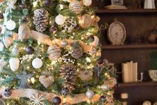 a pretty and chic rustic Christmas tree with burlap ribbons, black, grey and white ornaments, snowflakes, snowy pinecones and burlap hearts is amazing