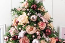 a pretty glam tabletop Christmas tree decorated with metallic and pastel ornaments, with glitter stars and pastel blooms