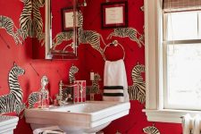 a refined red bathroom done with crazy red zebra print wallpaper, a large mirror cabinet, a glass shelf and vintage appliances